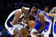 Orlando Magic's Wendell Carter Jr., left, and Philadelphia 76ers' Joel Embiid battle for the ball during the first half of an NBA basketball game, Monday, Nov. 29, 2021, in Philadelphia. (AP Photo/Matt Slocum)