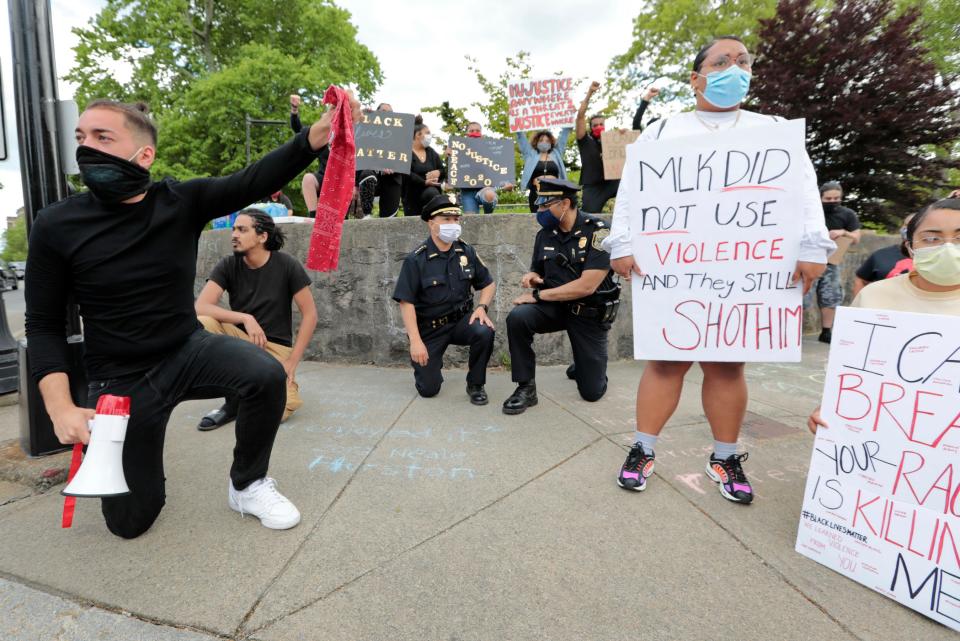 New Bedford police chief Joseph Cordeiro joins protestors in taking a knee in memory of George Floyd.  The protest started at the intersection of Union Street and County Street in downtown New Bedford and progressed to the site where Malcom Gracia was killed by police on Cedar Street in 2012.