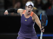 Catherine McNally of the United States reacts after winning a point against Australia's Samantha Stosur during their first round singles match at the Australian Open tennis championship in Melbourne, Australia, Monday, Jan. 20, 2020. (AP Photo/Andy Wong)