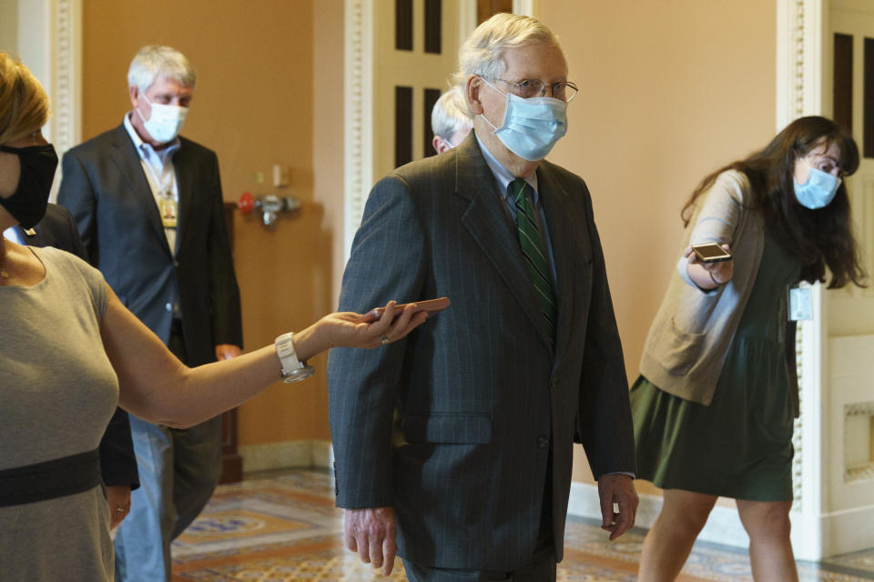 Senate Majority Leader Mitch McConnell of Ky., center, walks to his office from the Senate floor, Tuesday, Sept. 8, 2020, on Capitol Hill in Washington. (AP Photo/Jacquelyn Martin)