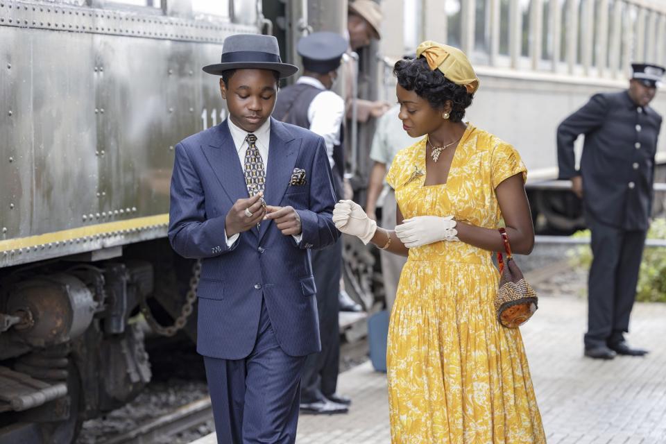 A woman walks with her son at a train station