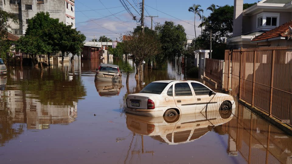 Cars are surrounded by flooded streets after heavy rain in Canoas, in Rio Grande do Sul state, on May 9, 2024. - Carlos Macedo/AP