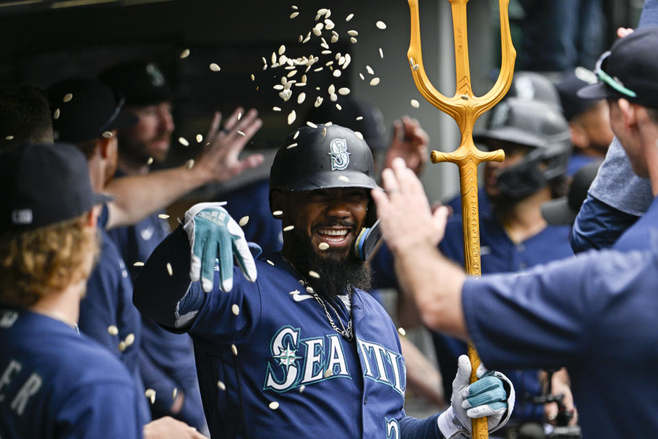 SEATTLE, WASHINGTON - AUGUST 30: Teoscar Hernandez #35 of the Seattle Mariners celebrates with teammates after hitting a three-run home run during the third inning against the Oakland Athletics at T-Mobile Park on August 30, 2023 in Seattle, Washington. (Photo by Alika Jenner/Getty Images)