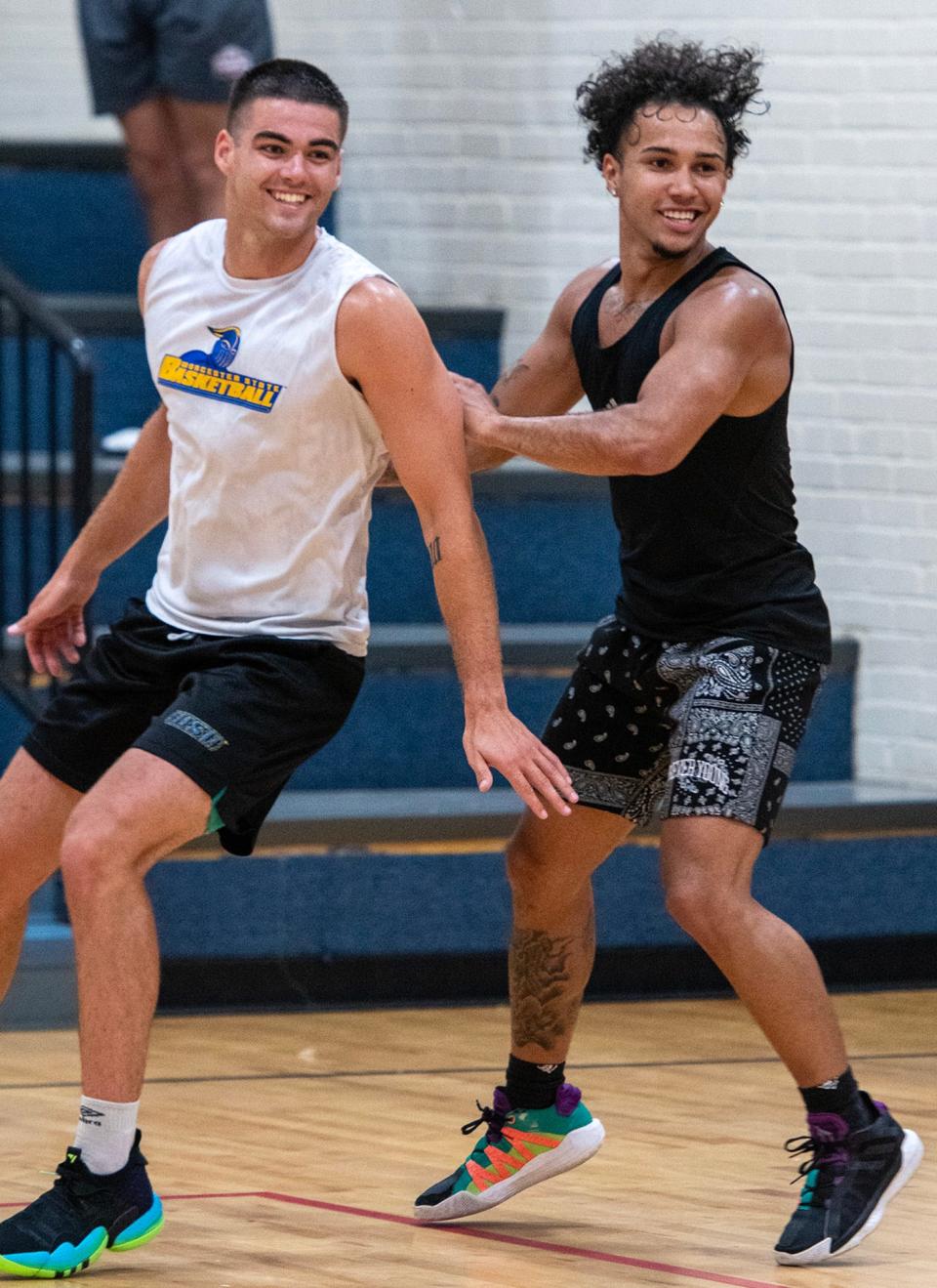 Dan Liberatore, left, and L.J. Hicks share a laugh as play moves to the other side of the small court.