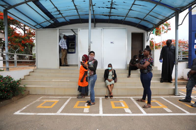 People wait within markings to use the automated teller machine (ATM), as authorities ease the lockdown following the coronavirus disease (COVID-19) outbreak, in Abuja