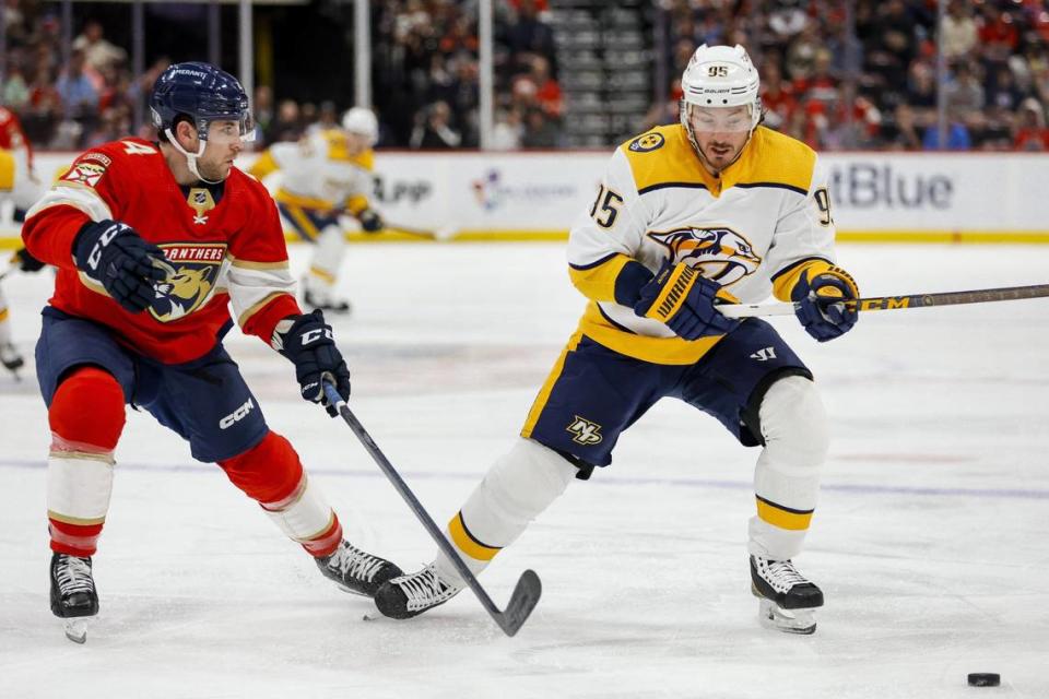 Mar 2, 2023; Sunrise, Florida, USA; Nashville Predators center Matt Duchene (95) moves the puck as Florida Panthers defenseman Casey Fitzgerald (4) defends during the first period at FLA Live Arena. Mandatory Credit: Sam Navarro-USA TODAY Sports