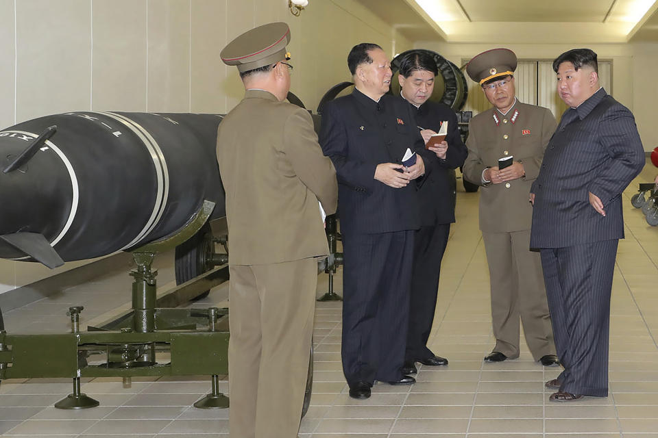 This photo provided on Tuesday, March 28, 2023, by the North Korean government, North Korean leader Kim Jong Un, right, talks with military officials at a hall displayed what appeared to be various types of warheads designed to be mounted on missiles or rocket launchers on March 27, 2023, in undisclosed location, North Korea. Independent journalists were not given access to cover the event depicted in this image distributed by the North Korean government. The content of this image is as provided and cannot be independently verified. (Korean Central News Agency/Korea News Service via AP)