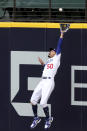 Los Angeles Dodgers right fielder Mookie Betts makes a catch against the outfield wall robbing a home run from Atlanta Braves designated hitter Marcell Ozuna of a hit during the fifth inning in Game 6 of baseball’s National League Championship Series, Saturday, Oct. 17, 2020, in Arlington, Texas. (Curtis Compton/Atlanta Journal-Constitution via AP)
