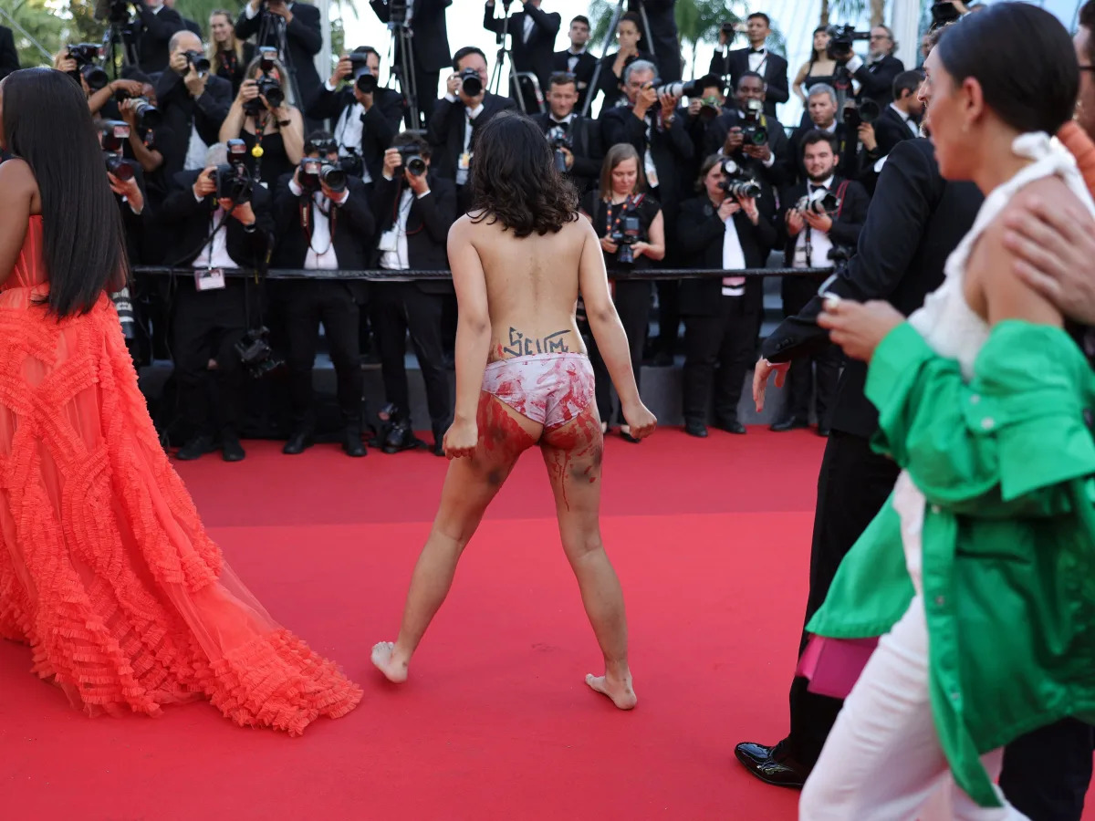 Topless woman storms Cannes Film Festival red carpet to protest against Russian ..