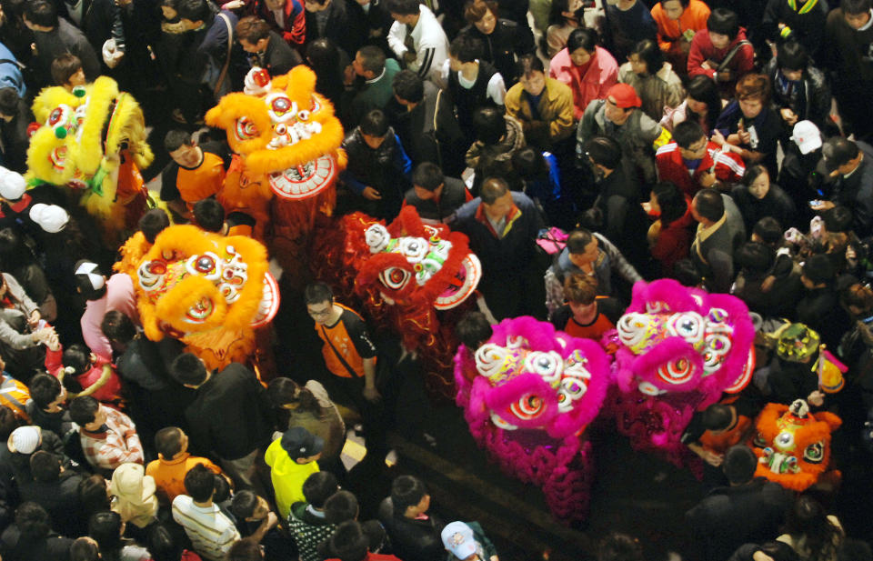 Surrounded by thousands of worshippers, lion dancers perform before the start of the Dajia Mazu Pilgrimage Trip early Saturday morning, April 17, 2010, in Dajia, on the central east coast of Taiwan. The effigy of Mazu and many thousands of followers will travel some 280 kilometers (174 miles) to sister Mazu temples, at the Dajia Jenn Lann Temple, . Mazu is said to protect fishermen and sailors and widely worshiped in the south-eastern coastal areas of China and neighbouring areas in Southeast Asia, all of which have strong sea-faring traditions.(AP Photo/Chiang Ying-ying)