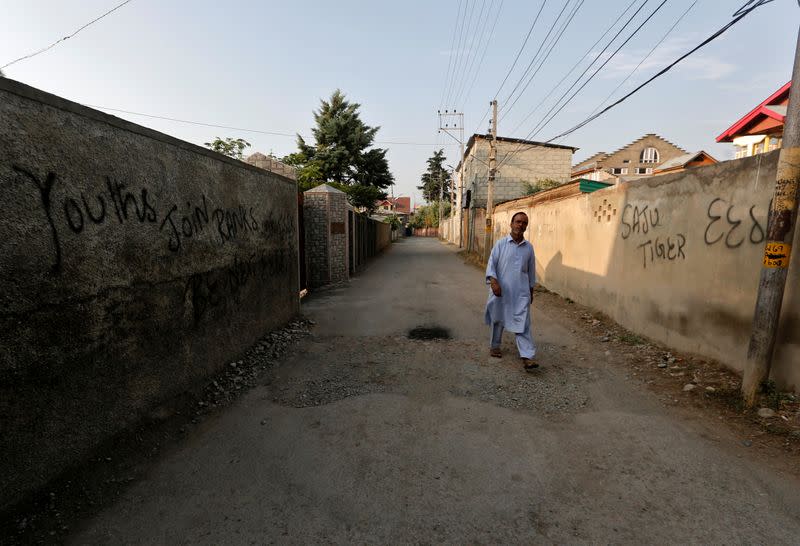 Kashmiri man walks on a road in Anchar neighbourhood in Srinagar