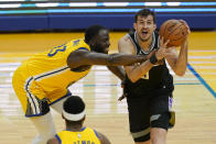 Sacramento Kings forward Nemanja Bjelica, right, drives against Golden State Warriors forward Draymond Green during the first half of an NBA basketball game in San Francisco, Monday, Jan. 4, 2021. (AP Photo/Jeff Chiu)