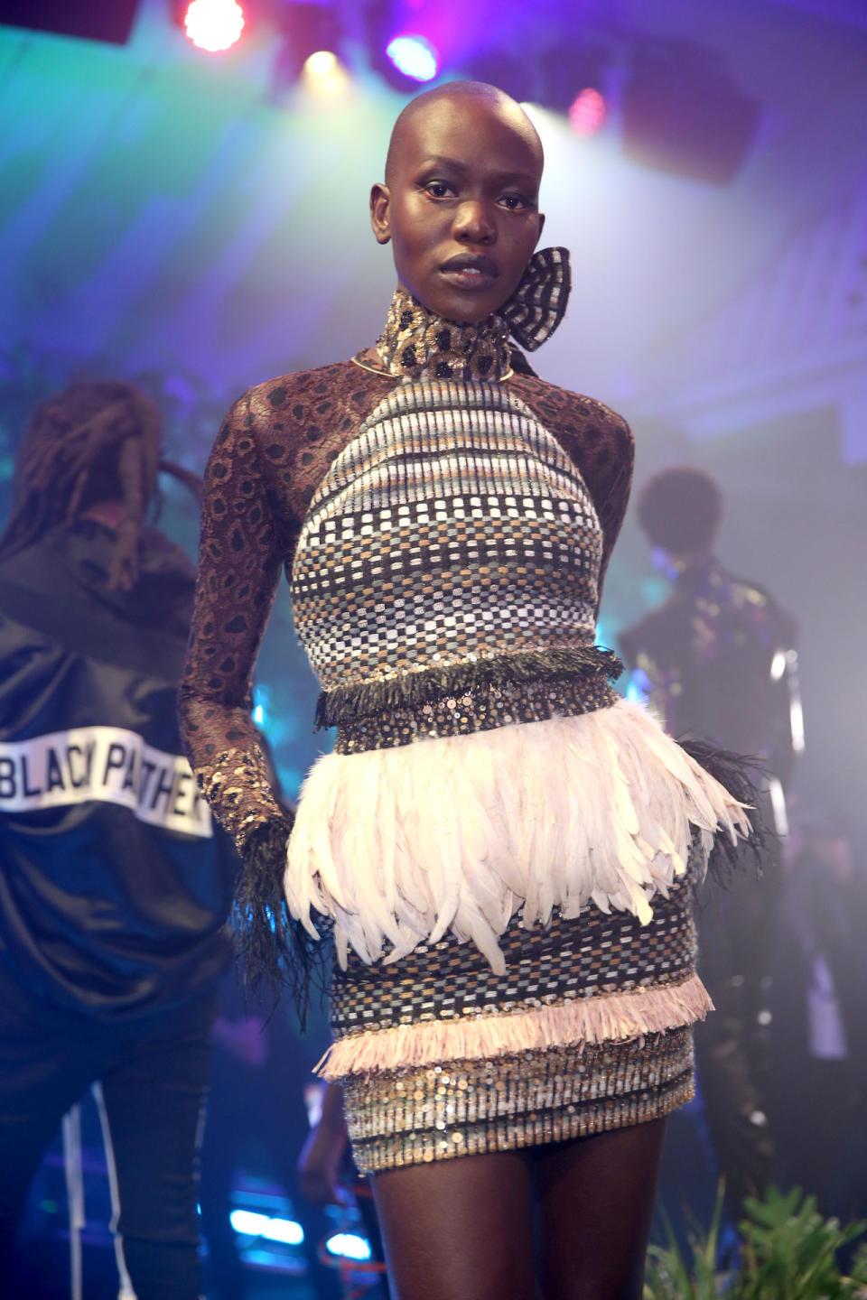 <p>Model wears a woven embroidered dress with feather waist band by Sophie Theallet at the Black Panther Welcome to Wakanda NYFW fashion presentation. (Photo: Courtesy of Marvel Studios Black Panther/Getty) </p>