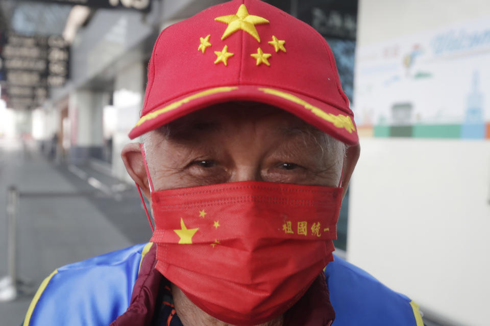 A supporter wears a cap and mask featuring China National flag, outside of Taoyuan International Airport as former Taiwan President Ma Ying-jeou leaves for China in Taoyuan City, northern Taiwan, Monday, March 27, 2023. Ma is scheduled to visit China Monday on a 12-day tour, a day after Taiwan lost another one of its diplomatic allies to China. (AP Photo/Chiang Ying-ying)