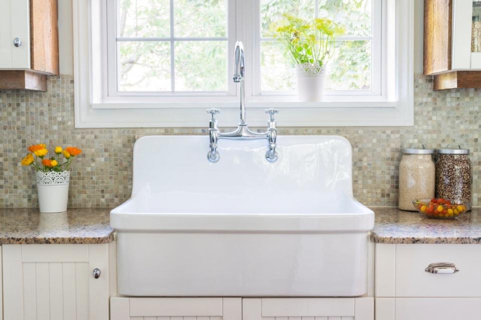 Large white rustic farmhouse sink in kitchen.