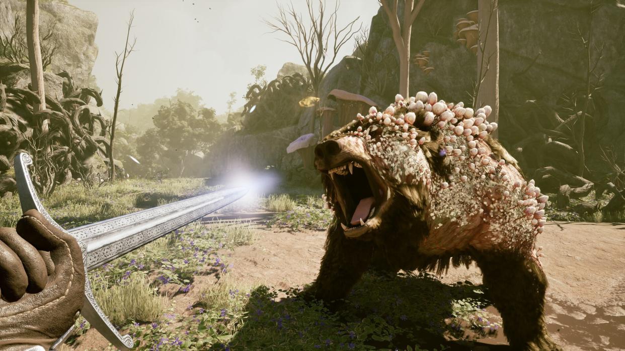  A screenshot from the Avowed trailer at the Xbox Games Showcase 2023 showing a plague-infected bear attacking a sword-wielding character 