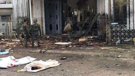 ATTENTION EDITORS - VISUAL COVERAGE OF SCENES OF INJURY OR DEATH Soldiers walk beside victims after an explosion in Jolo Cathedral, in Jolo, Sulu province, Philippines January 27, 2019. Armed Forces of the Philippines - Western Mindanao Command/Handout via REUTERS