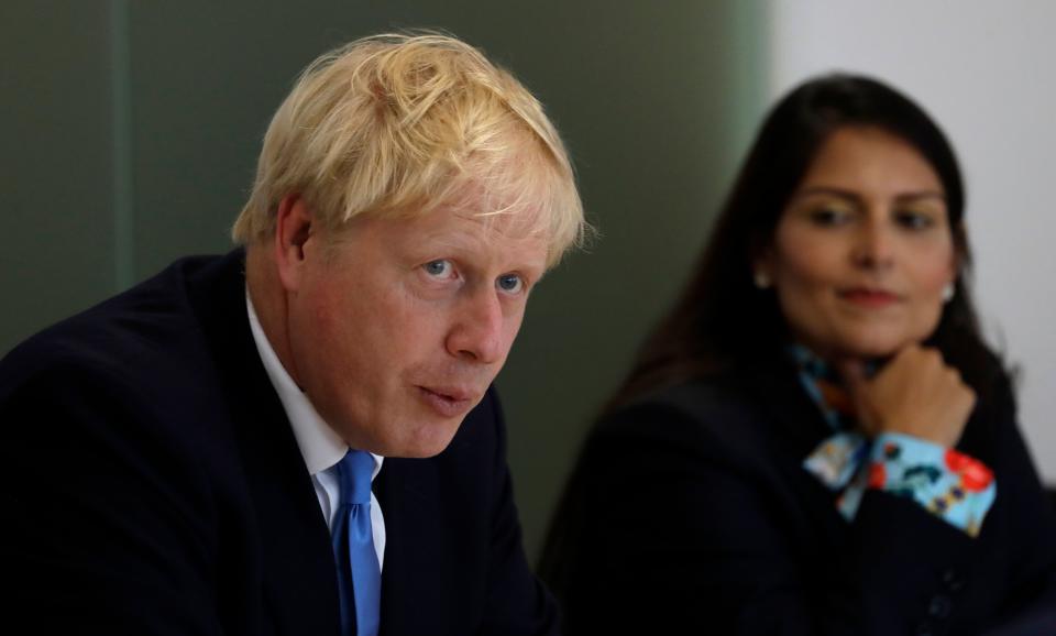 Britain's Prime Minister Boris Johnson (L), accompanied by Britain's Home Secretary Priti Patel, speaks at the first meeting of the National Policing Board at the Home Office in London, on July 31, 2019. (Photo by Kirsty Wigglesworth / POOL / AFP) (Photo credit should read KIRSTY WIGGLESWORTH/AFP via Getty Images)