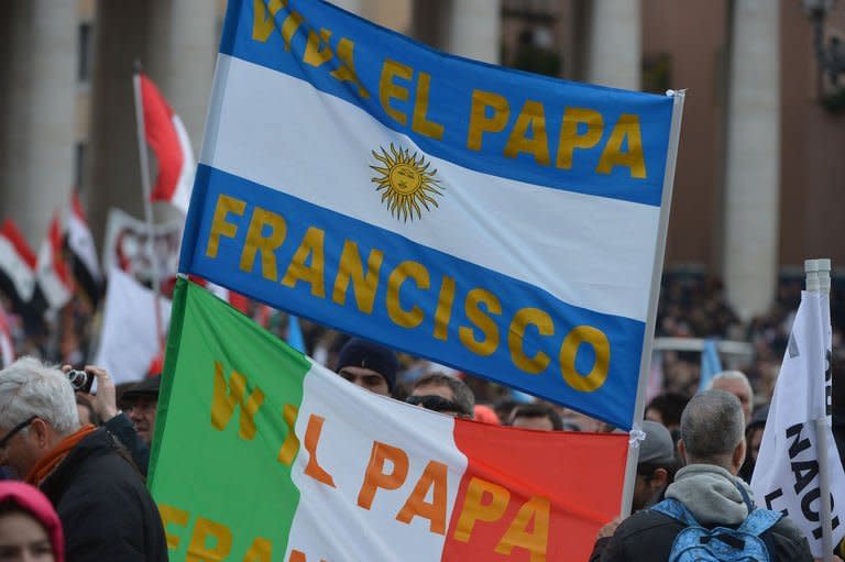 Faithfuls wave flags before pope's first Angelus prayer at St Peter's Square on March 17, 2013