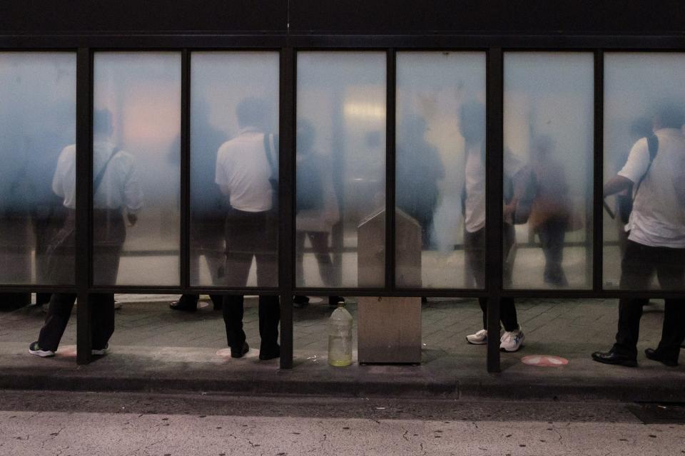 People in a designated smoking area outside