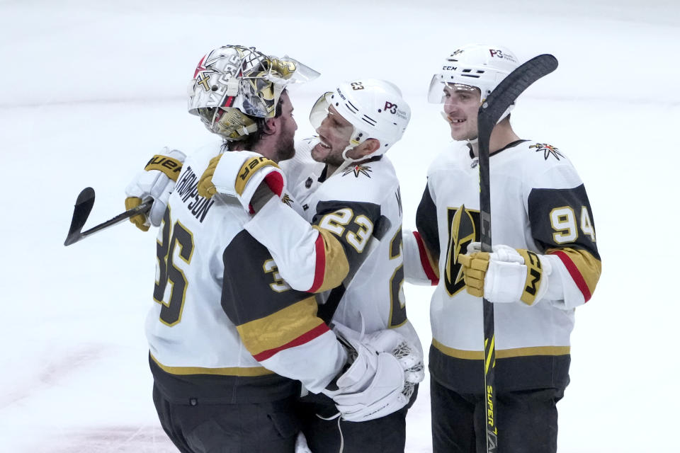 Vegas Golden Knights goaltender Logan Thompson (36) Alec Martinez, and Brayden Pachal celebrate the team's 4-1 win over the Chicago Blackhawks after an NHL hockey game Thursday, Dec. 15, 2022, in Chicago. (AP Photo/Charles Rex Arbogast)