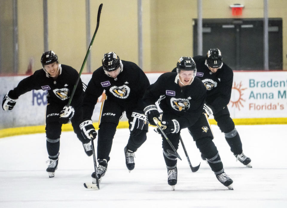 From left to right, Pittsburgh Penguins' Chad Ruhwedel, Matt Bartkowski, Jake Guentzel and Brian Boyle attend an NHL hockey practice Thursday, Sept. 23, 2021, in Cranberry Township, Pa. (Andrew Rush/Pittsburgh Post-Gazette via AP)