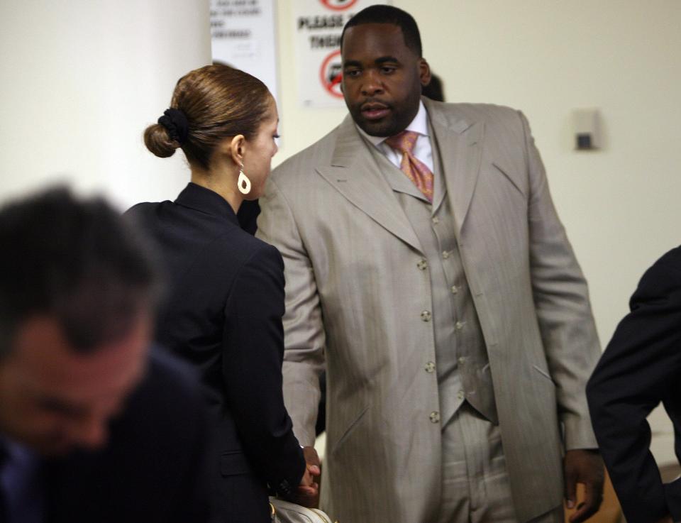 Christine Beatty, former chief of staff, shakes hands with Detroit Mayor Kwame Kilpatrick after the court ordered the release of some text messages at the 36th District Court in Detroit on Monday, July 14, 2008.