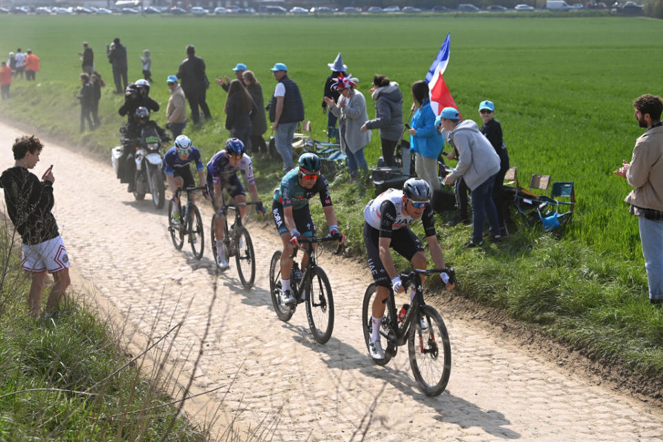 ROUBAIX FRANCE  APRIL 09 A general view of Jonas Koch of Germany and Team BORA  hansgrohe Derek Gee of Canada and Team Israel  Premier Tech Sjoerd Bax of The Netherlands and UAE Team Emirates Juri Hollmann of Germany and Movistar Team compete passing through a cobblestones sector compete while fans cheers during the 120th ParisRoubaix 2023 Mens Elite a 2566km one day race from Compigne to Roubaix on  UCIWT  April 09 2023 in Roubaix France Photo by Tim de WaeleGetty Images