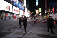 Police officers patrol New York's Times Square on foot, Wednesday night, April 29, 2020, during the coronavirus pandemic. The New York City immortalized in song and scene has been swapped out for the last few months with the virus version. In all the unknowing of what the future holds, there's faith in that other quintessential facet of New York City: that the city will adapt. (AP Photo/Mark Lennihan)