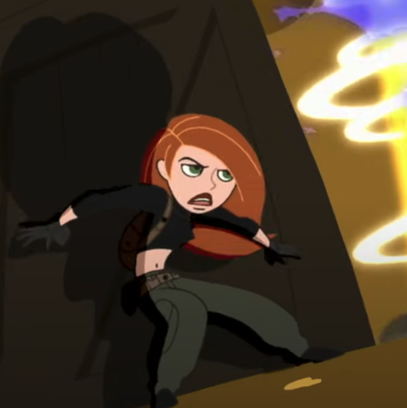 Kim Possible in action stance with glowing fist, ready for battle in animated scene