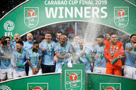 Soccer Football - Carabao Cup Final - Manchester City v Chelsea - Wembley Stadium, London, Britain - February 24, 2019 Manchester City's Vincent Kompany and team mates celebrate with the trophy after the match Action Images via Reuters/Carl Recine