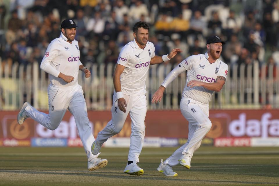 England's James Anderson, center, and teammate celebrate after the dismissal of Pakistan's Zahid Mahmood during the fifth day of the first test cricket match between Pakistan and England, in Rawalpindi, Pakistan, Monday, Dec. 5, 2022. (AP Photo/Anjum Naveed)