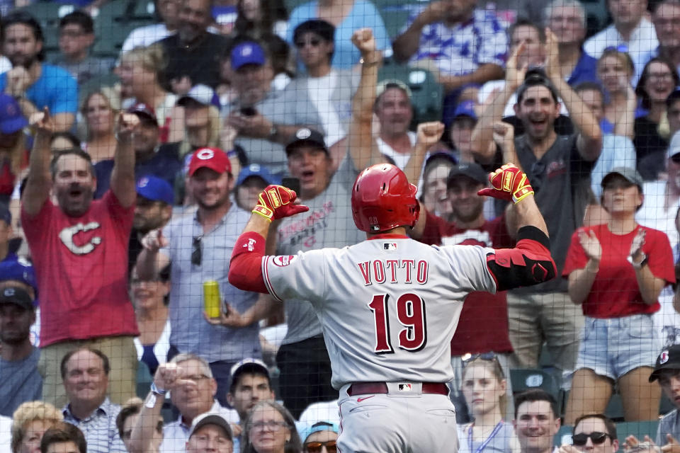 Cincinnati Reds' Joey Votto points to his name on his jersey after hitting a home run off Chicago Cubs starting pitcher Zach Davies during the second inning of a baseball game Wednesday, July 28, 2021, in Chicago. (AP Photo/Charles Rex Arbogast)