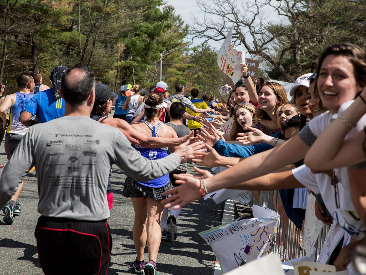 Crowds cheer on Boston Marathon runners in the iconic 'scream tunnel' near Wellesley College on April 17, 2017, in Wellesley Massachusetts: Getty images