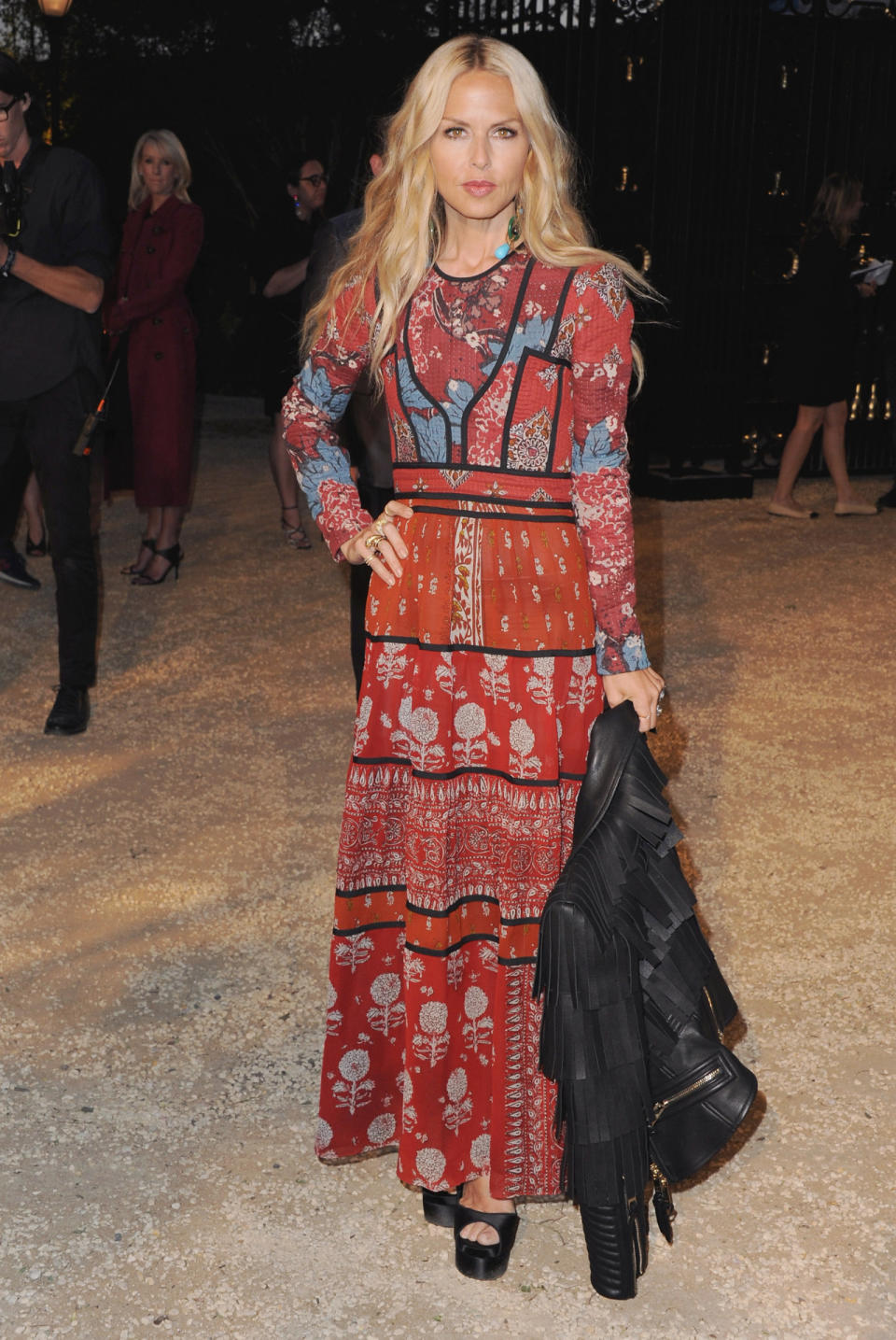 It’s almost as if the Burberry Prorsum 2015 Ready-to-Wear collection was made for Zoe with its hippie inspiration. She looks comfortable and cool in a red and floral ankle-length dress and the fringe leather jacket she’s carrying adds some edge.