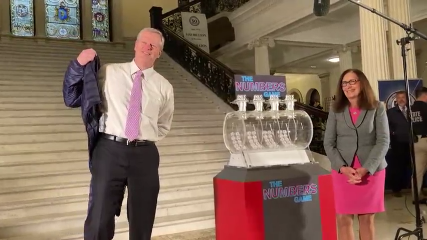 Gov. Charlie Baker helps the Massachusetts State Lottery celebrate its 50th birthday.