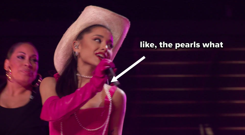 Ariana singing, with an arrow pointing from the caption "like, the pearls what" to the pearls she's wearing