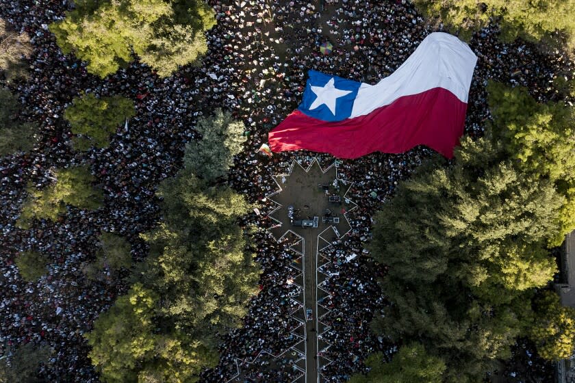 Supporters of presidential candidate Gabriel Boric, of the I approve Dignity coalition, attend his closing campaign rally ahead of the presidential run-off election in in Santiago, Chile, Thursday, Dec. 16, 2021. (AP Photo/Matias Delacroix)