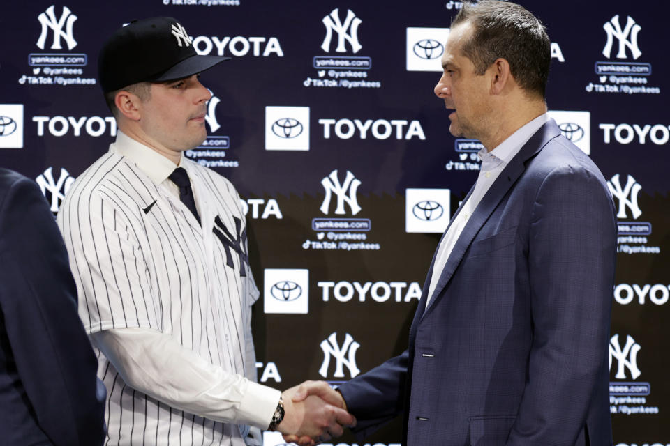 New York Yankees' Carlos Rodon, left, shakes hands with manager Aaron Boone during his introductory baseball news conference at Yankee Stadium, Thursday, Dec. 22, 2022, in New York. (AP Photo/Adam Hunger)