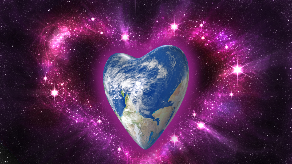 a glitter heart surrounds a heart shaped planet earth
