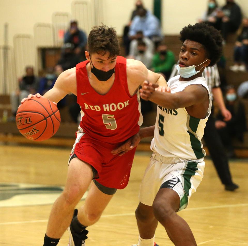 Red Hook's Brendan Donohue drives through Spackenkill's Nasir Snell during Tuesday's game in the Town of Poughkeepsie on December 7, 2021.