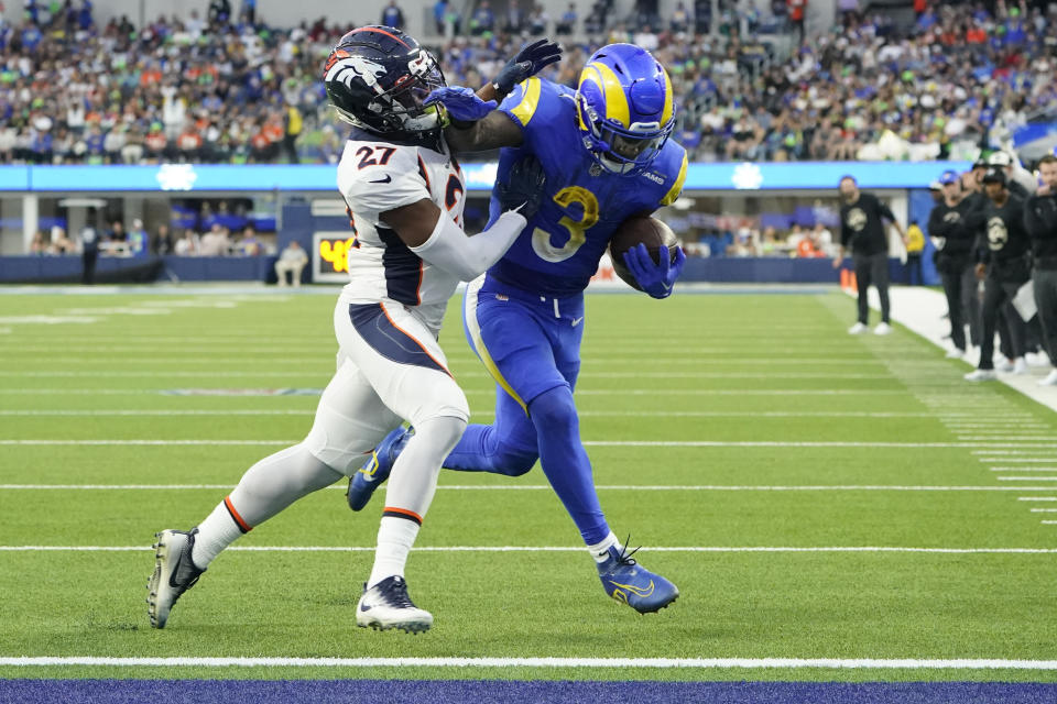 Los Angeles Rams running back Cam Akers scores past Denver Broncos cornerback Damarri Mathis during the second half of an NFL football game between the Los Angeles Rams and the Denver Broncos on Sunday, Dec. 25, 2022, in Inglewood, Calif. (AP Photo/Marcio J. Sanchez)