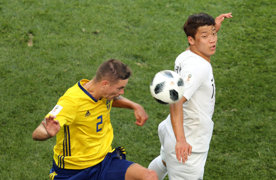 <p>Aerial battle: Mikael Lustig and Hwang Hee-chan compete for a header. (REUTERS/Lucy Nicholson) </p>