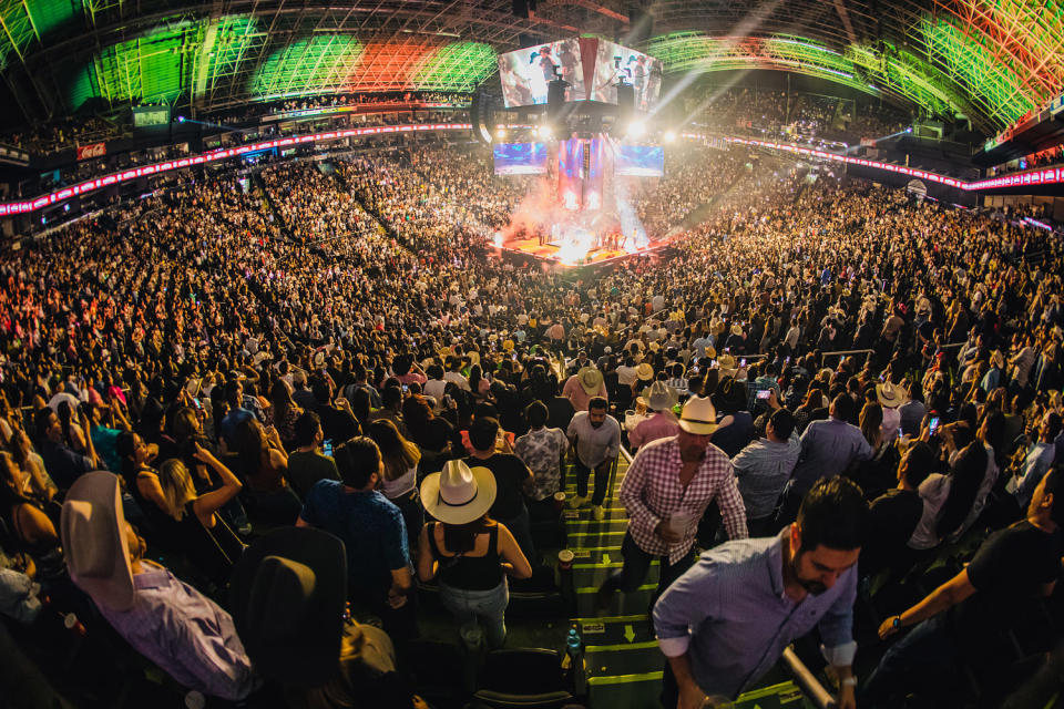 Grupo Frontera performing for a large crowd (Medios y Media / Getty Images)