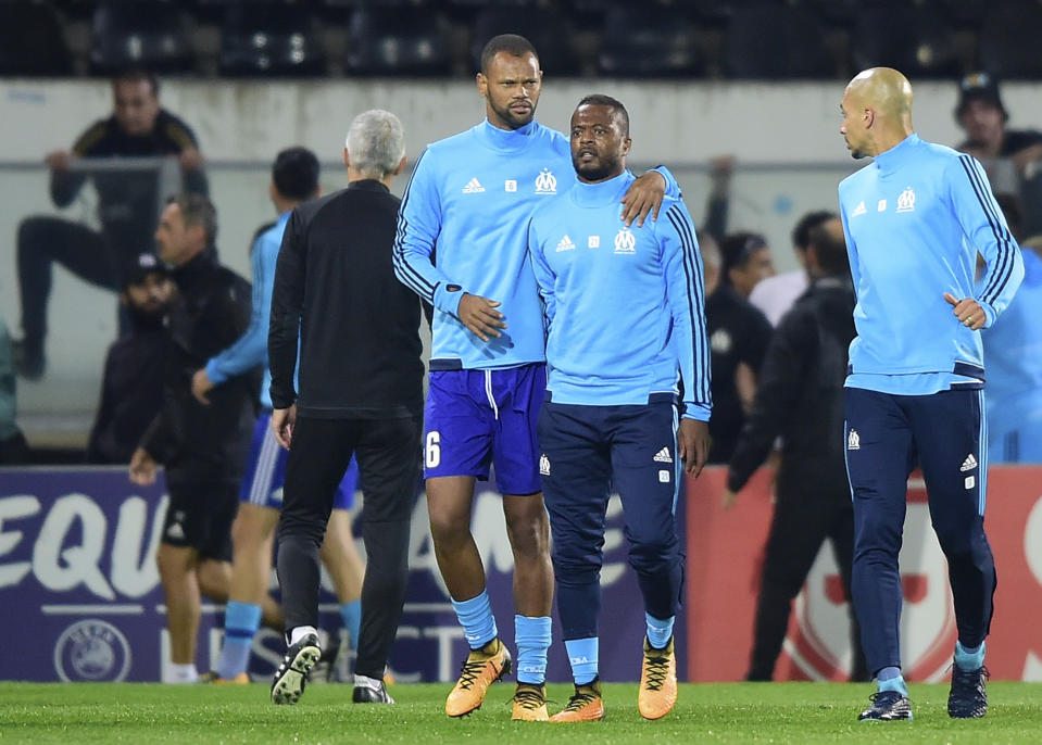 Bad blood: Marseille’s Patrice Evra, centre right, attacking one of his club’s own fans last night
