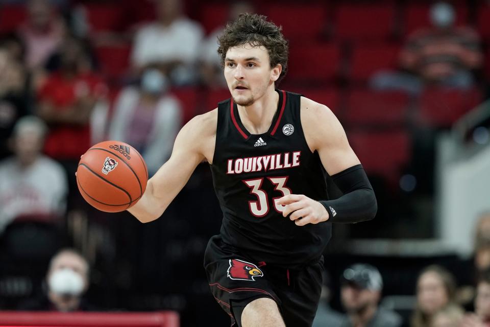 Louisville forward Matt Cross (33) dribbles against North Carolina State during the second half of an NCAA college basketball game in Raleigh, N.C., Saturday, Dec. 4, 2021. (AP Photo/Gerry Broome)