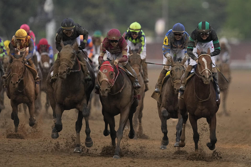 Brian Hernandez Jr. rides Mystik Dan, right, to the finish line to win the 150th running of the Kentucky Derby horse race at Churchill Downs Saturday, May 4, 2024, in Louisville, Ky. (AP Photo/Brynn Anderson)