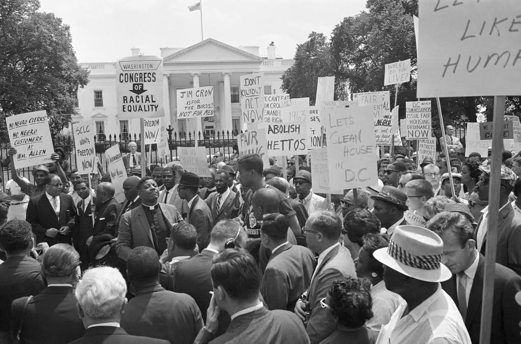 A group of demonstrators pause in front of the White House for a prayer, June 14, 1963. (AP Photo/Henry Burroughs, File)