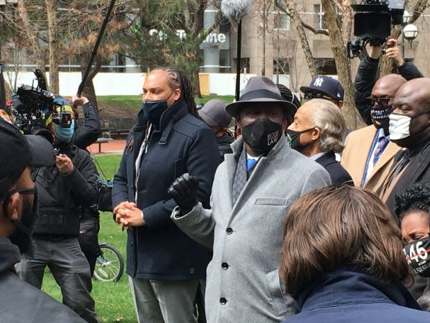 Ben Crump, centre, an attorney for the Floyd family, and Reverend Al Sharpton, centre-right, lead some of Floyd's family members, including brothers Philonise and Rodney Floyd, in prayer outside the Hennepin County Government Center during closing arguments in Chauvin's murder trial on Monday. 