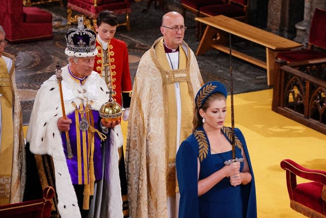 Lord President of the Council, Penny Mordaunt, holding the Sword of State walking ahead of the King during his coronation in 2023